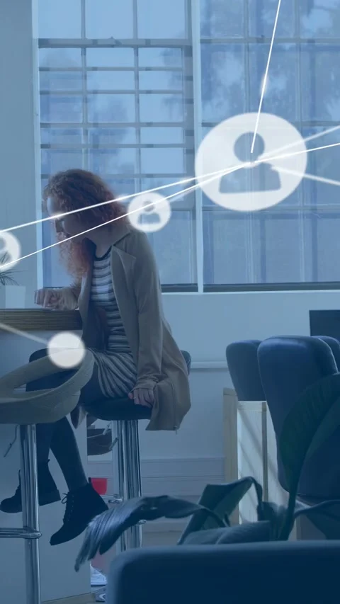 Vertical video: Woman tapping device at cafe causing network nodes sweeping over Stock Footage 332985075
