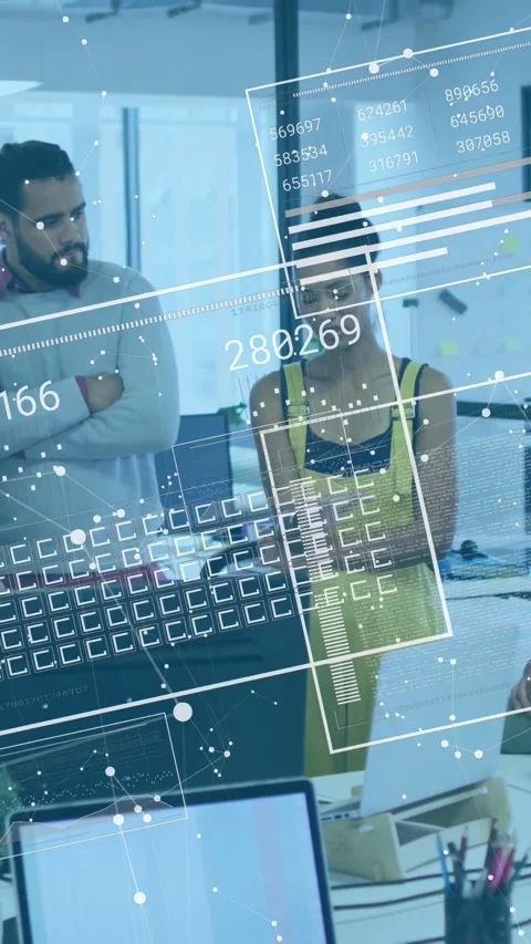 Vertical video: Woman tapping device by monitor, activating 3D data overlays Stock Footage 333174952