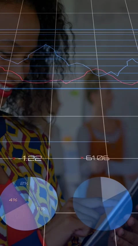 Vertical video: Woman tapping tablet in office causing business charts animating Stock Footage 333109626