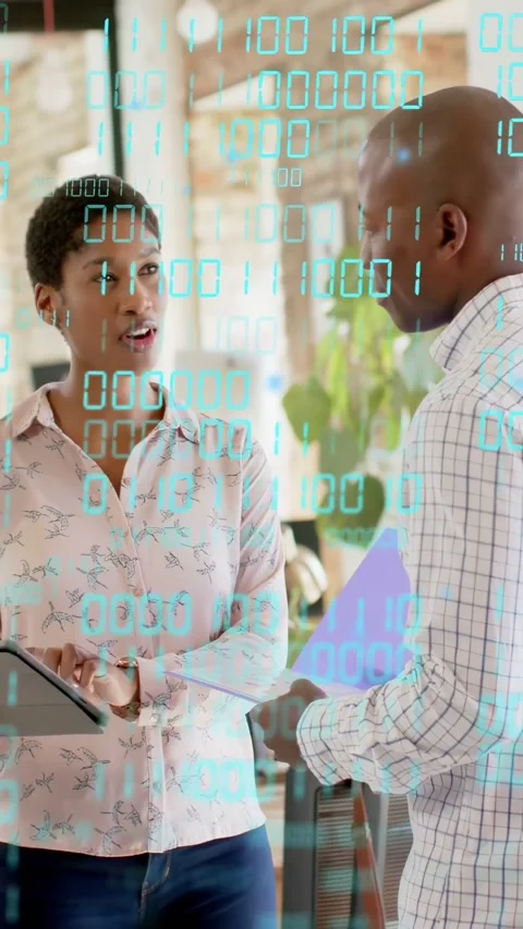 Vertical video: Woman tapping tablet and checking tech data showing binary Stock Footage 333157608
