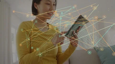 Vertical video: Woman tapping tablet on sofa, swiping as node map growing, Stock Footage 333192901