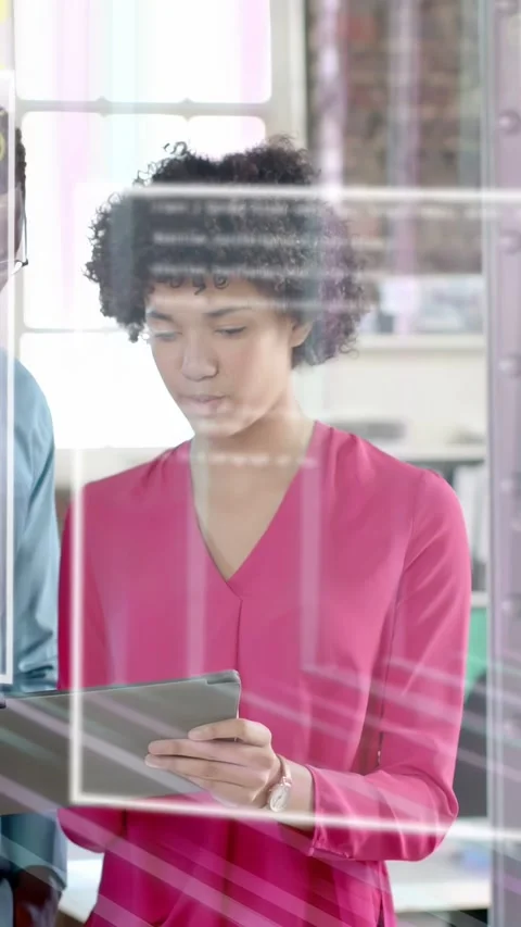Vertical video: Woman tapping tablet and man leaning initiating AR frames and Stock Footage 333479853