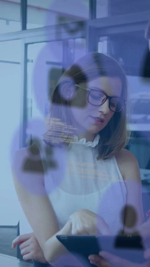 Vertical video: Woman tapping tablet, showing purple overlays revealing code and Stock Footage 333487012