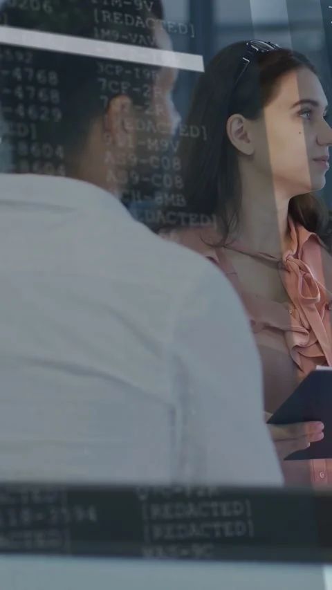 Vertical video: Woman tapping tablet and causing code overlay on glass, team Stock Footage 333527673
