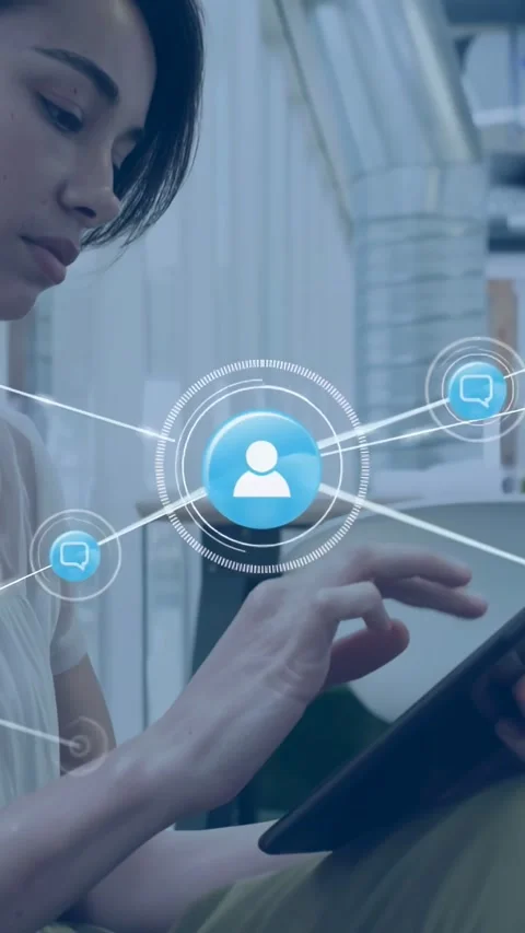 Vertical video: Woman tapping tablet and swiping, causing blue user node Vidéo 334386141