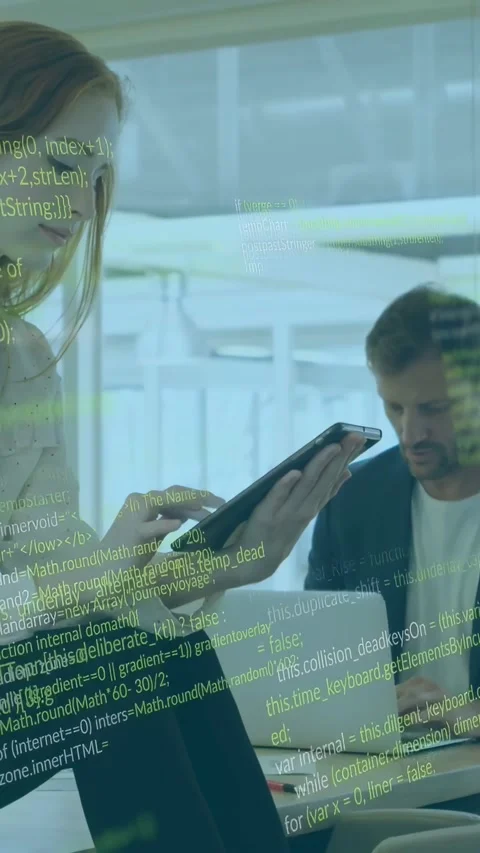 Vertical video: Woman tapping tablet sparking green code overlay, man typing on Stock Footage 334397420