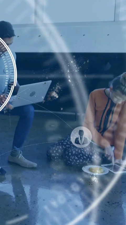 Vertical video: Woman tapping tablet starting tech work, man moving laptop, HUD Stock Footage 334546789