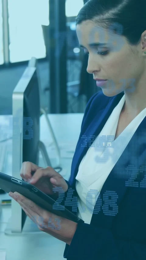 Vertical video: Woman tapping tablet, reviewing finance data, numeric overlays Stock Footage 335355381