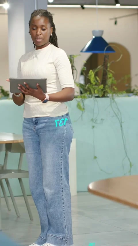 Vertical video: Woman tapping tablet, launching cyan AR data, colleague joining, Stock Footage 337540505