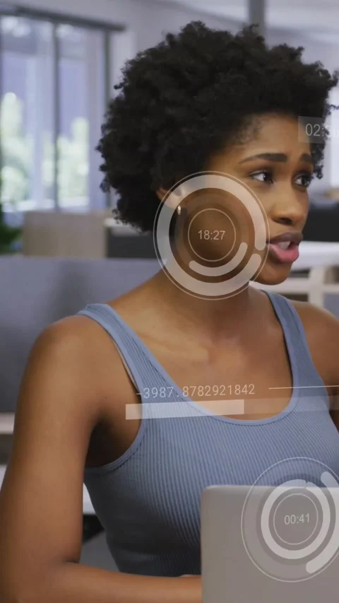 Vertical video: Woman in tech typing on laptop, starting HUD timers over torso, Stock Footage 332334917