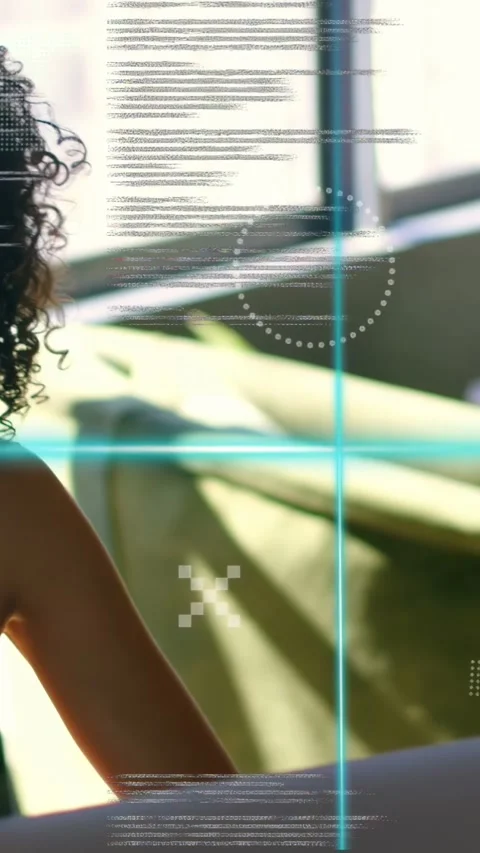 Vertical video: Woman testing code by window tapping laptop causing teal Stock Footage 334836992