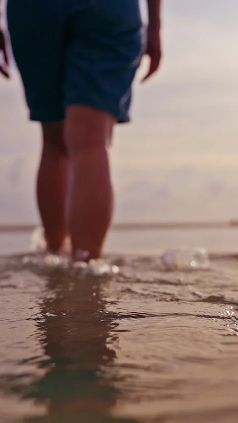 Vertical video. Woman Throwing Plastic Bottle into Shallow Sea at Sunset, Irresp Stock Footage 329060685