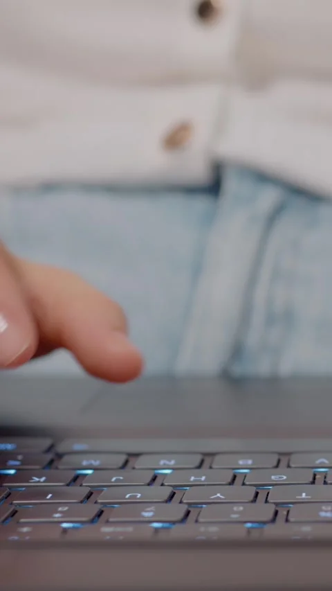 Vertical video Woman typing quickly on a laptop in a relaxed and casual setting Stock Footage 329623778