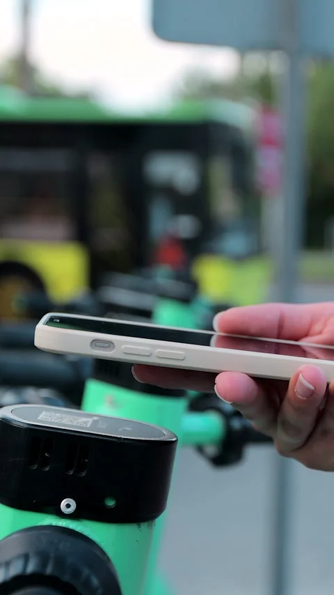 Vertical video. Woman using app on smartphone to unlock electric scooter Stock-Footage 344430249