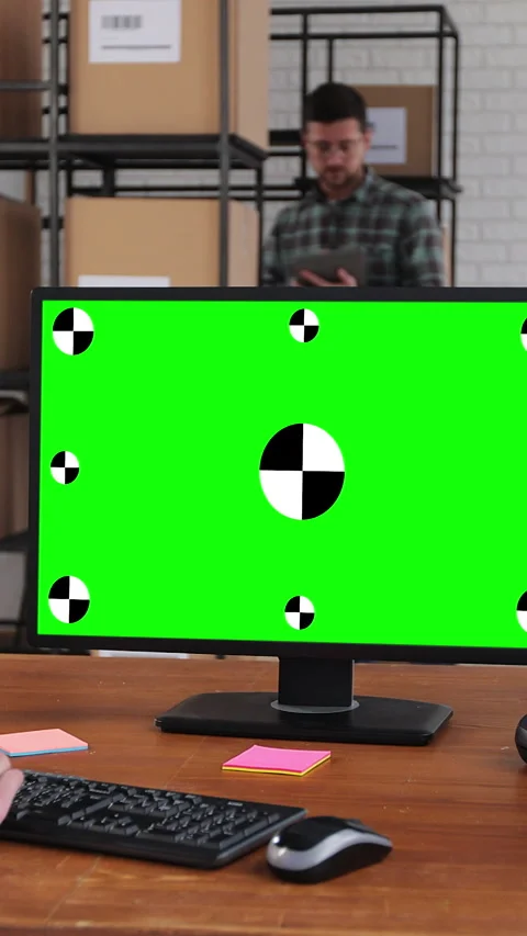 Vertical video. Woman using desktop computer with green screen color display. Stock Footage 345738048