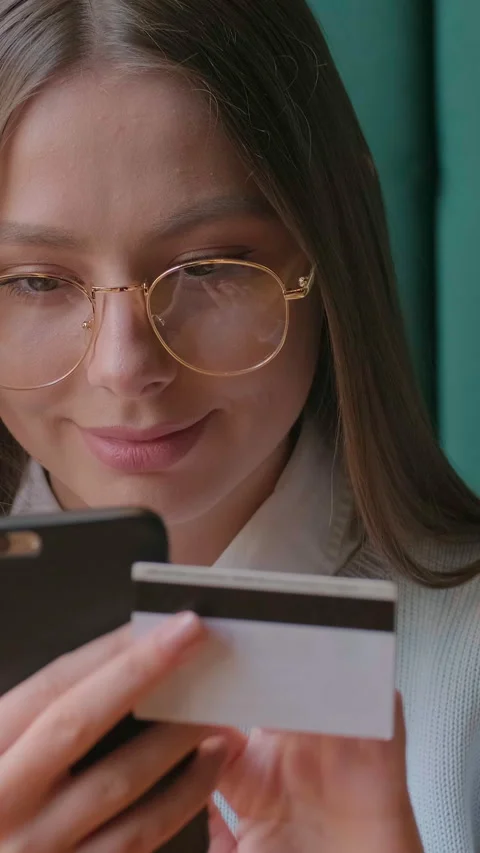 Vertical video. Woman using smartphone for online shopping and banking at home. Stock Footage 340980494