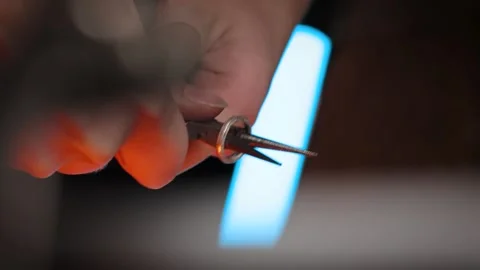 Vertical video women's hands work with tongs jewelry master working with metal Stock Footage 260867932