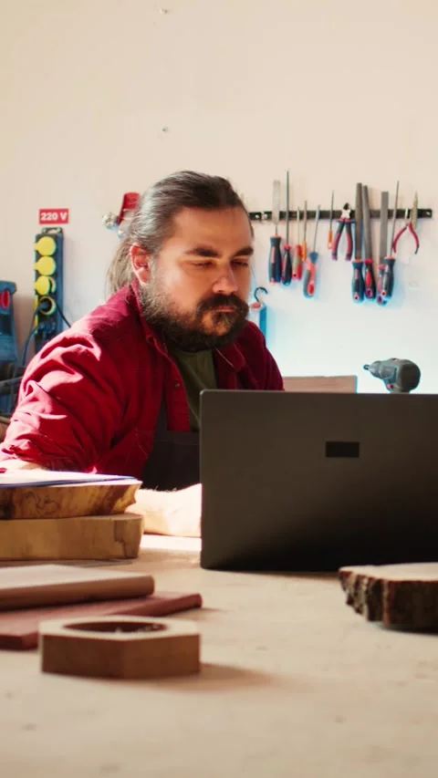 Vertical video Woodworkers using laptop to design wooden objects, pointing Video stock 271306890