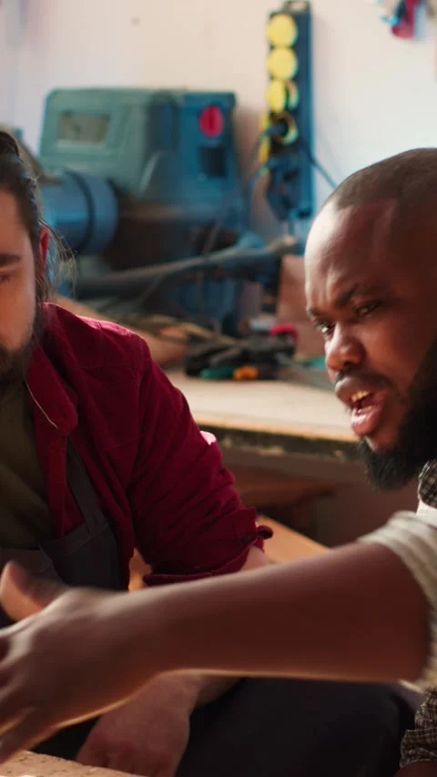 Vertical video Woodworkers using laptop to design wooden objects, pointing Video stock 271406582