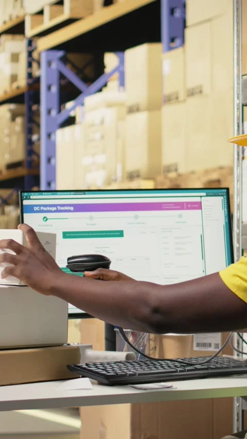 Vertical Video Worker applying labels and scanning tracking info numbers on Stock Footage 315189759