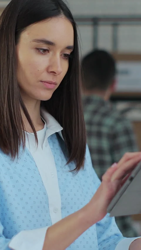 Vertical video. Worker checking inventory, writing notes on tablet. Stock Footage 345733027