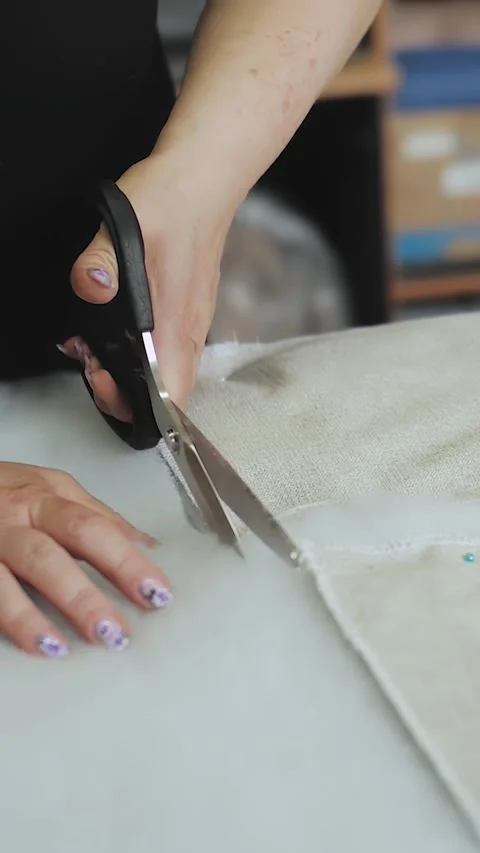 Vertical video. Worker cuts foam rubber with scissors, close-up of hand Stock Footage 323451383