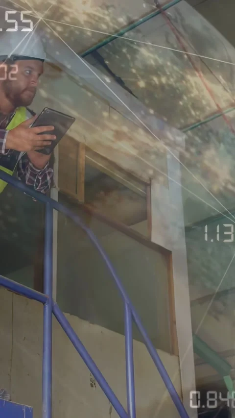 Vertical video: Worker descending blue stair, using tablet, showing AR data for Stock Footage 334601226