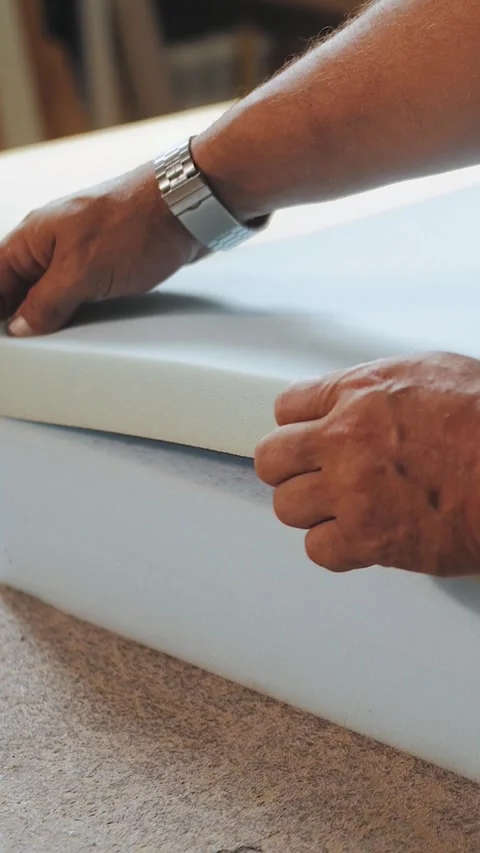 Vertical video. Worker glues foam for the production of upholstered furniture Stock Footage 323451416