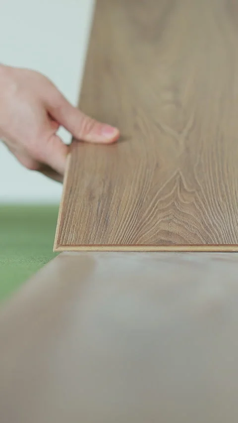 Vertical video Worker, lays laminate on a green backing. Video stock 339060601