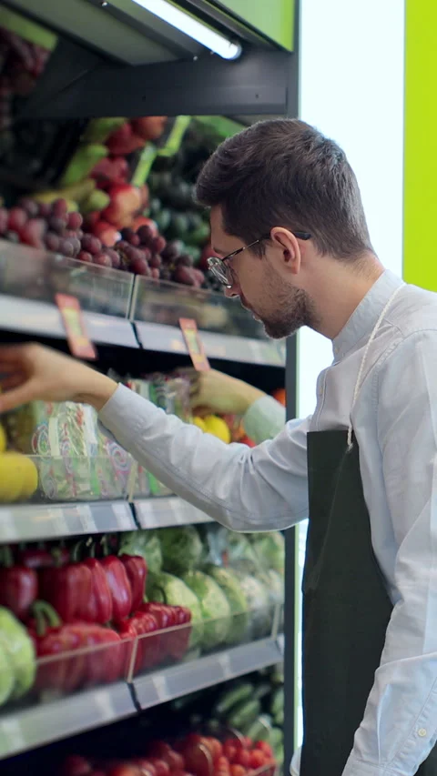Vertical video. Worker stocking lemons in supermarket. Stock Footage 346684667