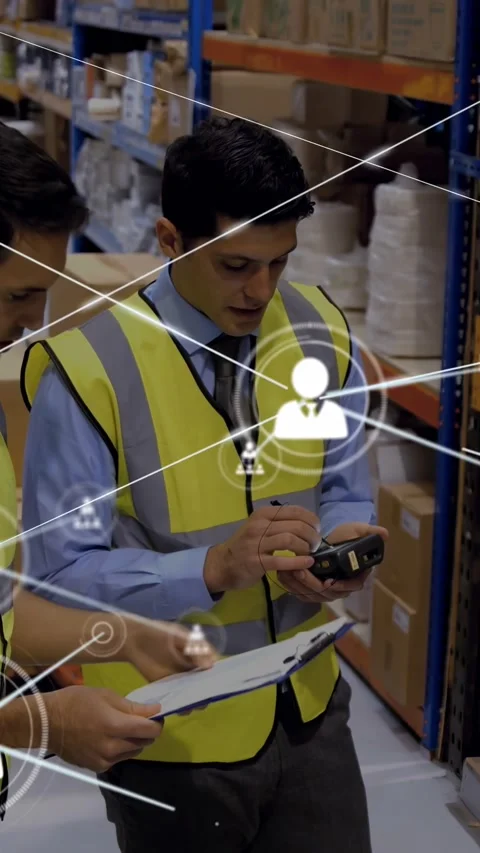 Vertical video: Worker tapping scanner peer checking list in depot causing data Stock Footage 329913198