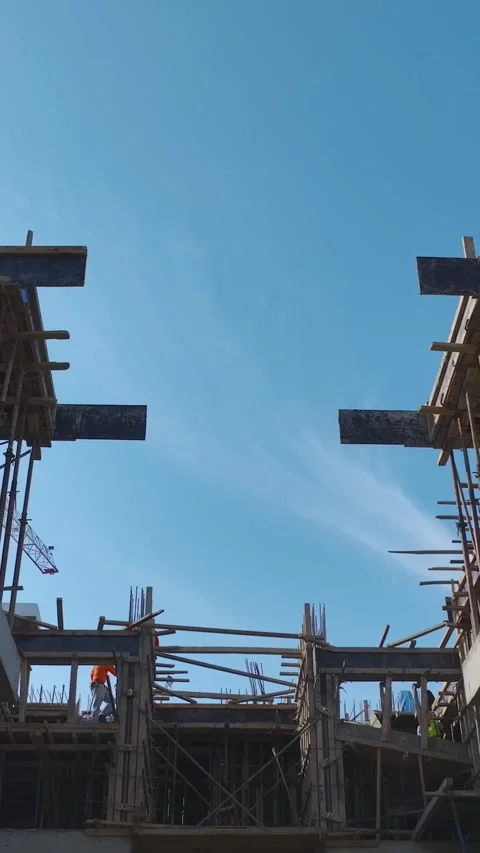 Vertical Video: Workers Actively Using Tools, Metal Framework, and Concrete Stock Footage 342905715