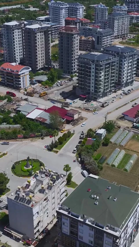 Vertical Video: Workers build homes in a new neighborhood, performing tasks from Video stock 297673761