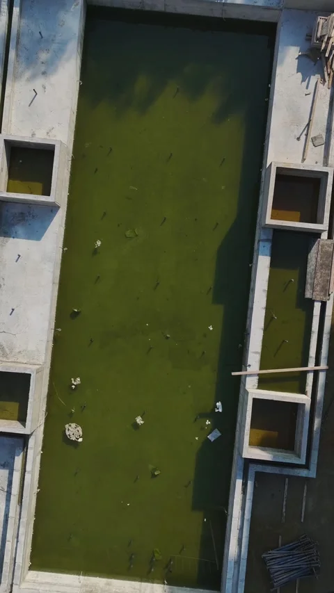 Vertical Video: Workers Building Walls Using Concrete Mixers, Tools, and Metal Stock Footage 342598529