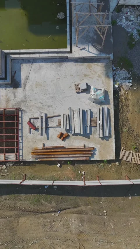 Vertical Video: Workers Building Walls Using Metal, Concrete, and Tools While Stock Footage 342908074