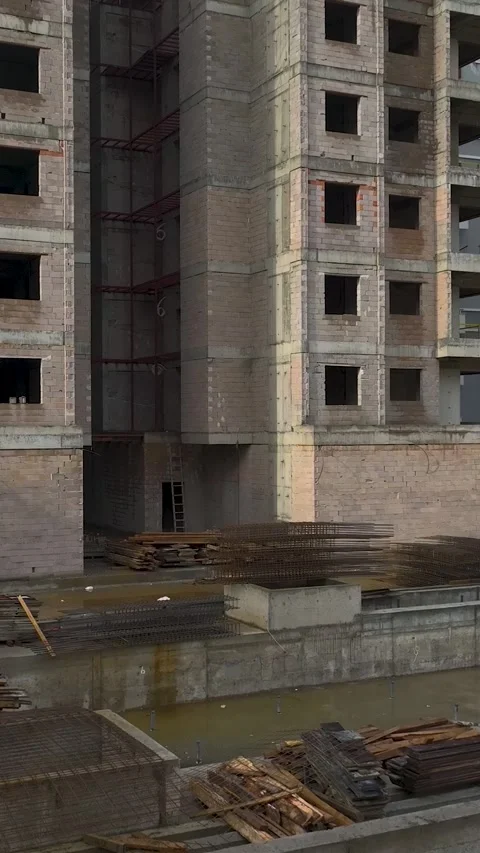 Vertical Video of Workers Completing Exterior Layer of High-Rise Wall Stock Footage 342407205