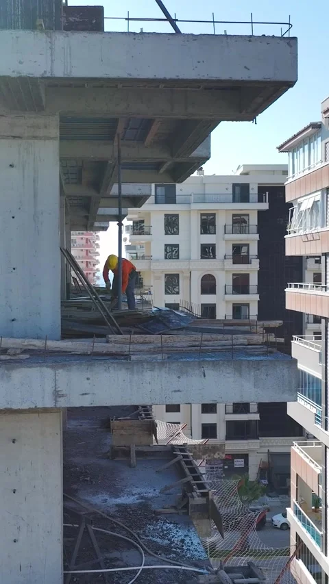 Vertical Video: Workers Completing a Variety of Tasks on a Construction Site Stock Footage 342691746
