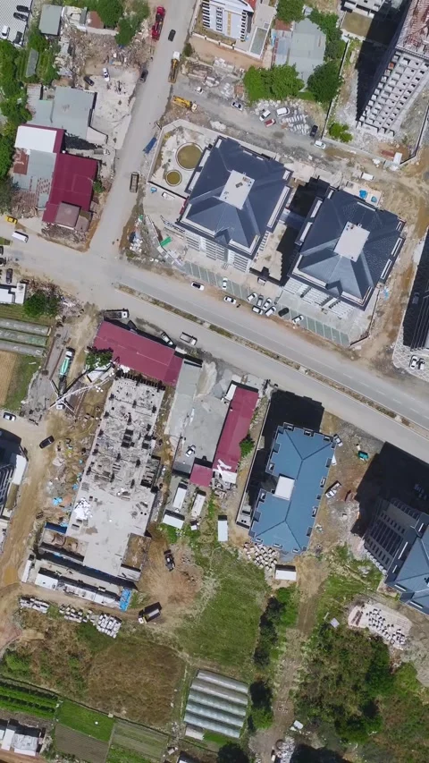 Vertical Video: Workers at a construction site completing tasks like concrete Stock Footage 297673172