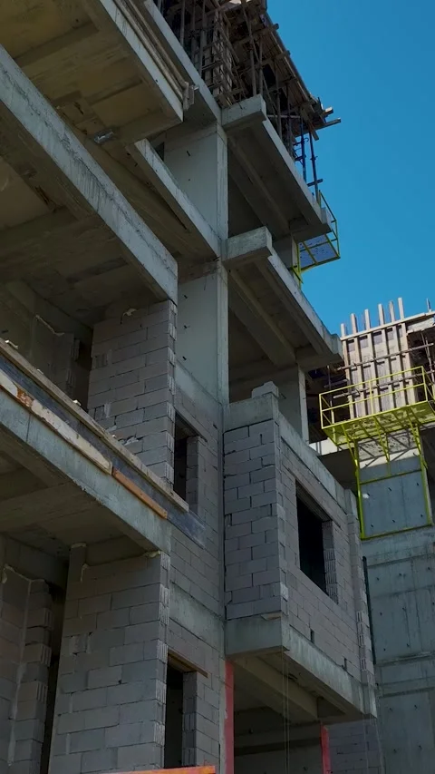 Vertical video workers on construction site with city and mountains Stock Footage 341841411