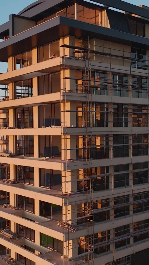 Vertical Video: Workers Installing Facade Elements on a Building Under Stock Footage 342684068