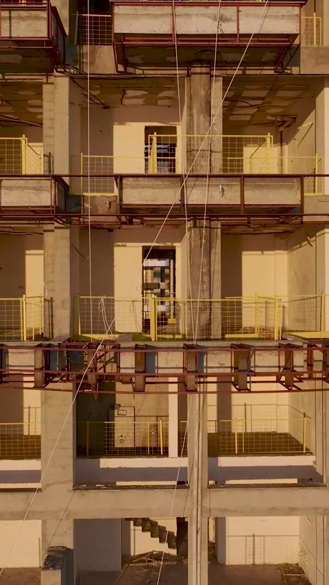 Vertical Video: Workers Installing Structural Elements on a Building Facade Stock Footage 342678759