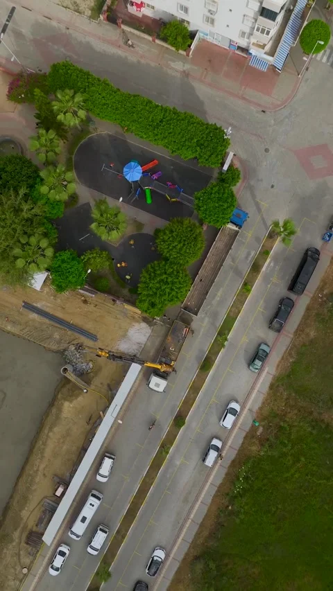 Vertical Video: Workers pour the initial layer of concrete into the foundation Stock Footage 297669391