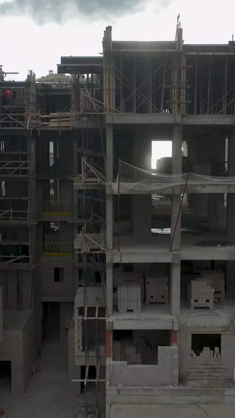 Vertical Video: Workers pouring concrete for the foundation of a residential Stock-Footage 297654663