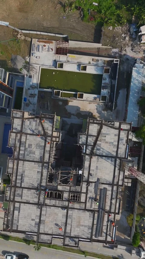 Vertical Video: Workers Using Metal Framework and Concrete Mixers to Build Video stock 342599026