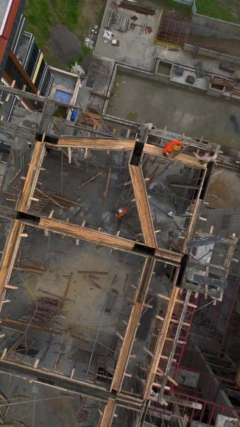 Vertical Video of Workers Using Tower Crane to Finish Concrete Exterior Walls Stock Footage 342407780