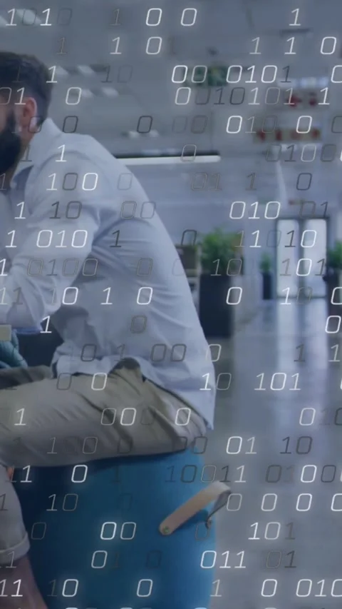 Vertical video: Working man in shirt khakis on blue stool at office, binary code Stock Footage 334317872