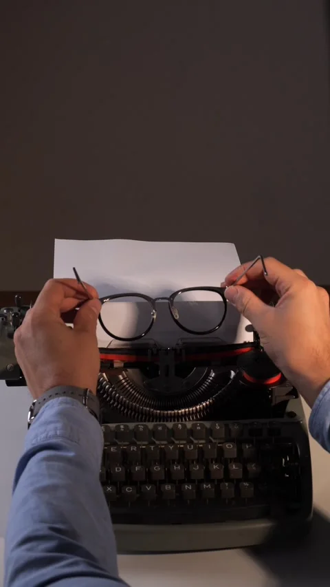Vertical video Writers hands holding elegant glasses over an old mechanical Stock Footage 322166530