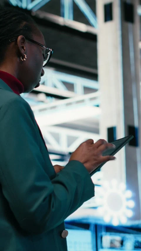 Vertical video Writing code, tablet and female programmer walking in data center Stock Footage 329650154