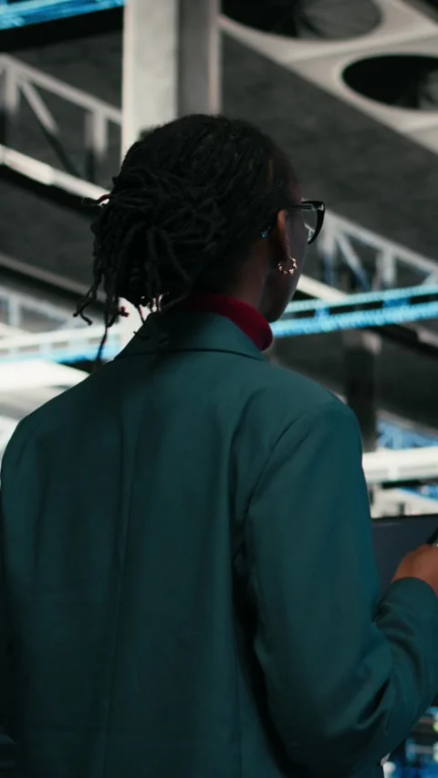 Vertical video Writing code, tablet application and programmer in data center Stock Footage 329713383