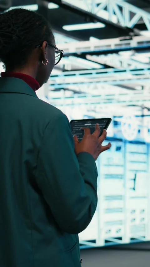 Vertical video Writing code, tablet and female programmer walking in data center 動画素材 329944485